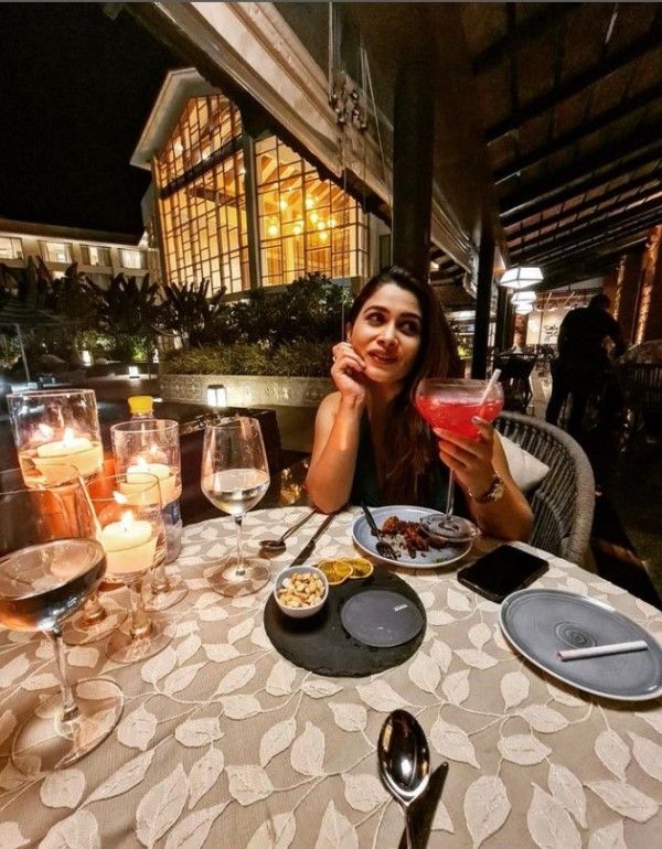 Ruchita Jadhav posing with an alcoholic beverage